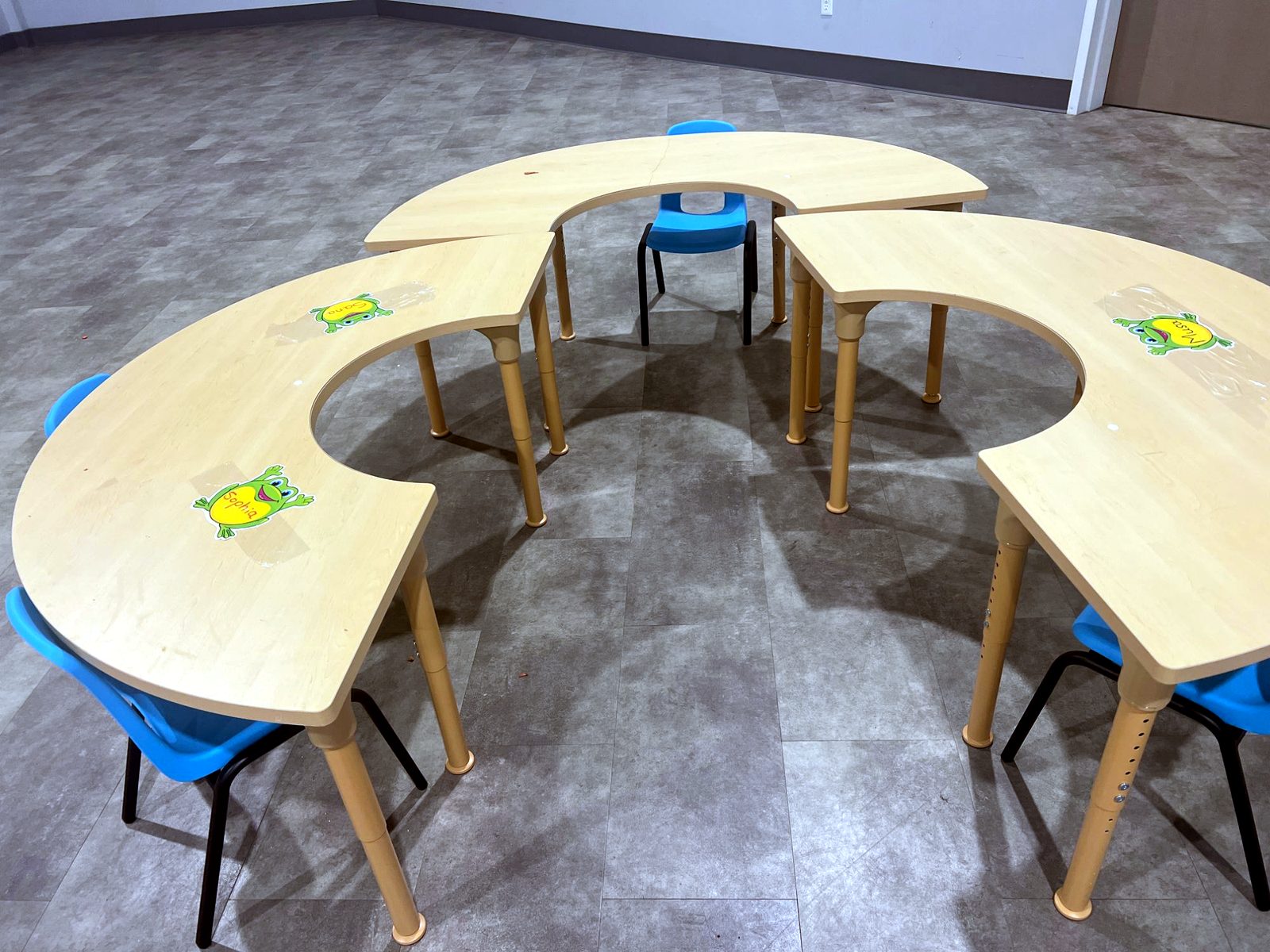Inside the PreK classroom — curved tables with a name at every seat